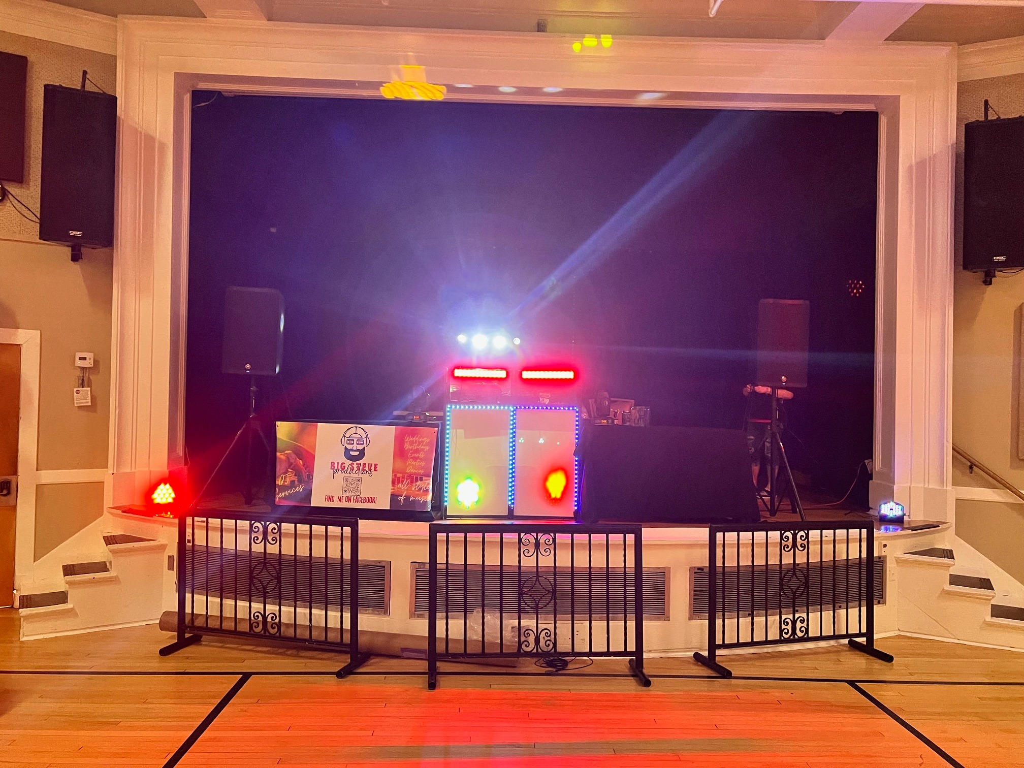 Big Steve Productions indoor DJ booth with stage lighting and speakers