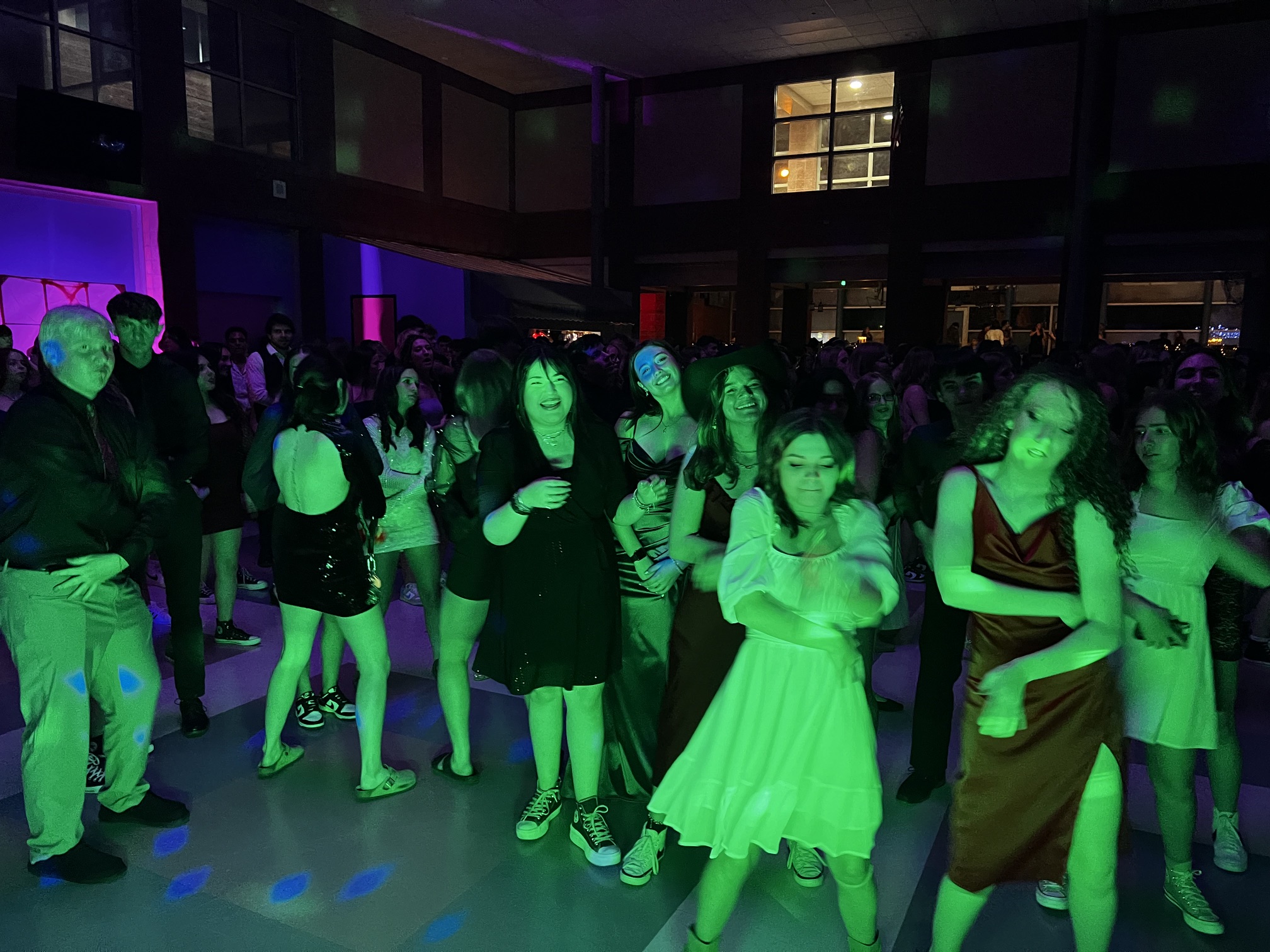 Crowd enjoying colorful DJ lighting